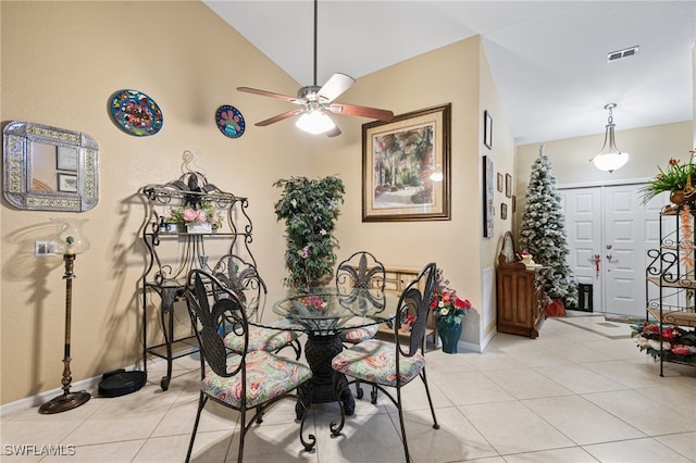 dining area with high vaulted ceiling, light tile patterned floors, and ceiling fan