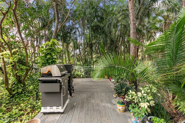 wooden deck featuring a grill