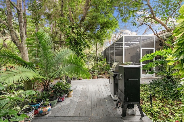 wooden terrace with area for grilling and glass enclosure