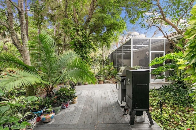7452 Berkshire Pines Dr, Naples, FL 34104 - wooden deck with glass enclosure and area for grilling