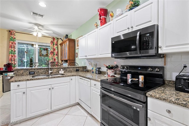 7452 Berkshire Pines Dr, Naples, FL 34104 - kitchen with double oven range, stainless steel microwave, dishwasher, ceiling fan, and backsplash