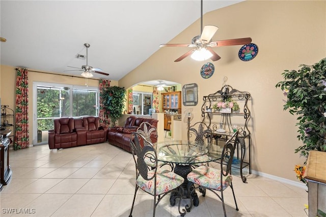 7452 Berkshire Pines Dr, Naples, FL 34104 - dining room featuring a ceiling fan, light tile patterned floors, arched walkways, and lofted ceiling