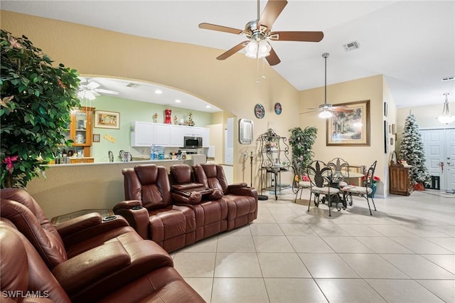 7452 Berkshire Pines Dr, Naples, FL 34104 - living room featuring ceiling fan, arched walkways, light tile patterned flooring, and vaulted ceiling