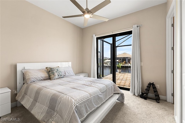 carpeted bedroom featuring ceiling fan, a water view, and access to outside