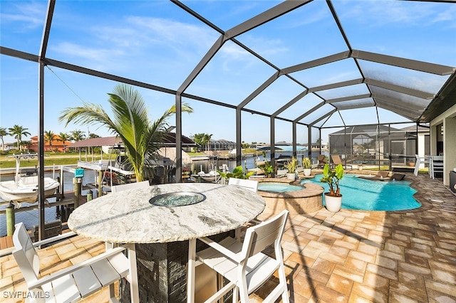 view of patio / terrace featuring a water view, glass enclosure, and a pool with hot tub