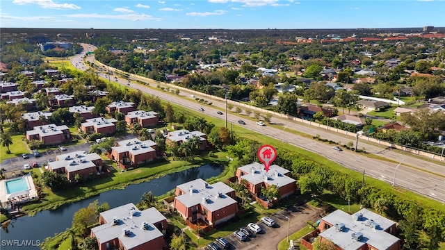 drone / aerial view featuring a residential view and a water view