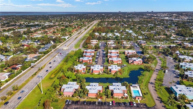 drone / aerial view with a residential view and a water view