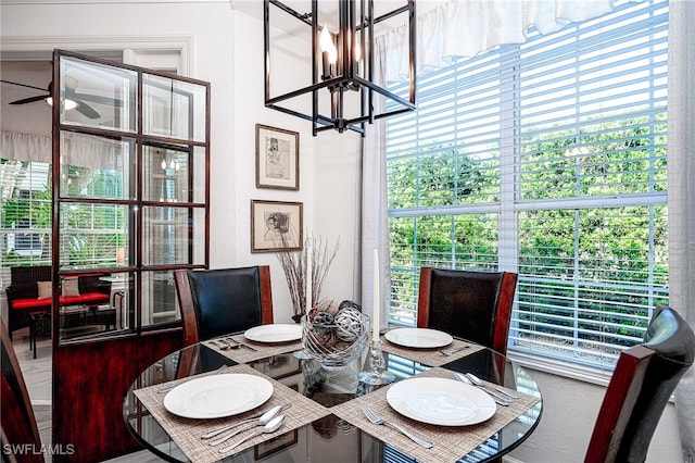 dining space featuring a healthy amount of sunlight and an inviting chandelier