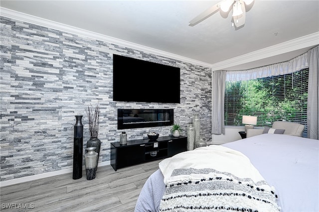 bedroom featuring hardwood / wood-style floors, ceiling fan, and crown molding