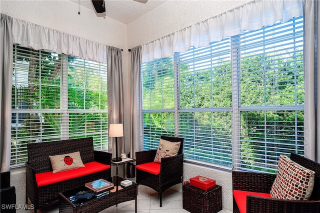 sunroom / solarium featuring plenty of natural light and ceiling fan