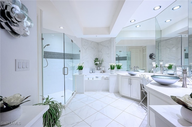 bathroom featuring vanity and shower with separate bathtub