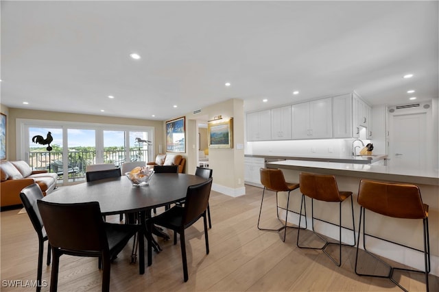 dining area featuring light hardwood / wood-style flooring and sink