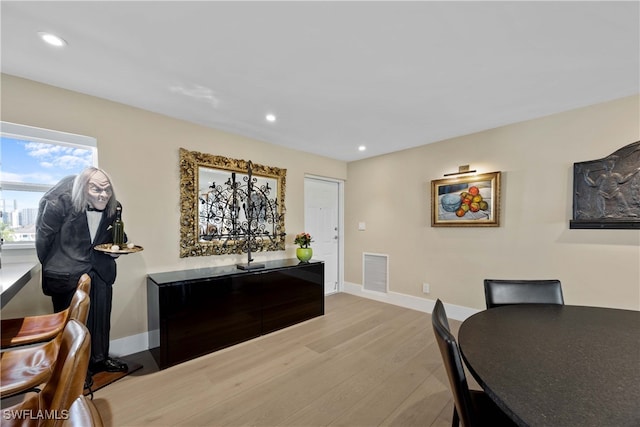 dining space with light hardwood / wood-style floors