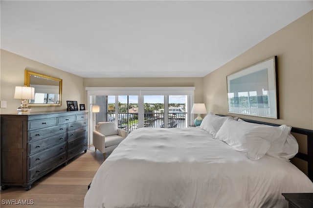 bedroom with access to exterior and light wood-type flooring