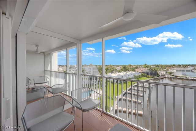 balcony with a water view and ceiling fan