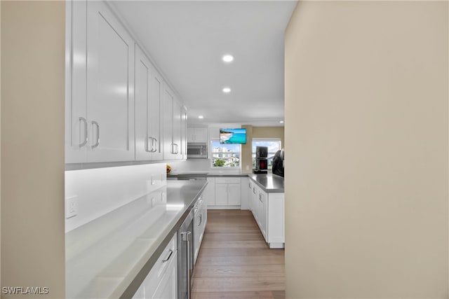 kitchen with white cabinets and light hardwood / wood-style floors