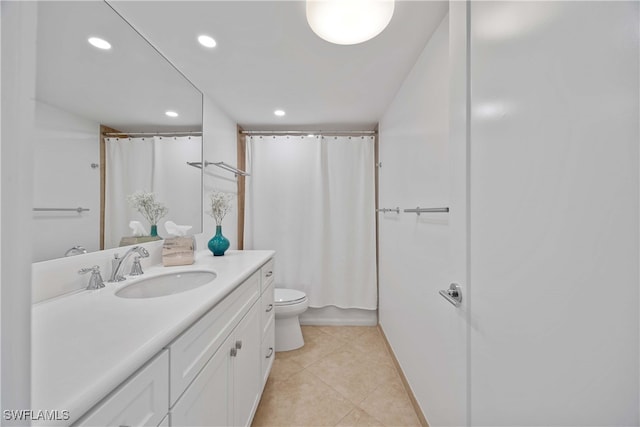 bathroom featuring toilet, vanity, and tile patterned flooring