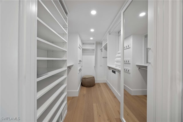 spacious closet featuring light hardwood / wood-style flooring