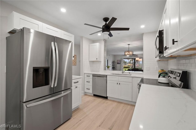 12170 Kelly Sands Way Unit 702, Fort Myers, FL 33908 - kitchen with stainless steel appliances, backsplash, a sink, ceiling fan, and recessed lighting