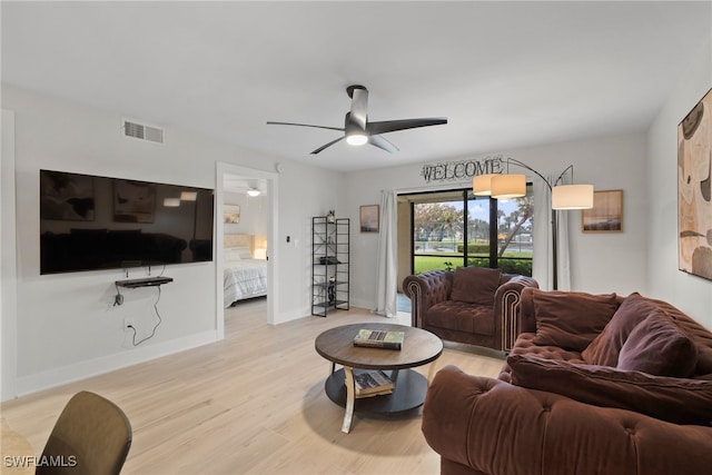 living room featuring ceiling fan and light wood-type flooring