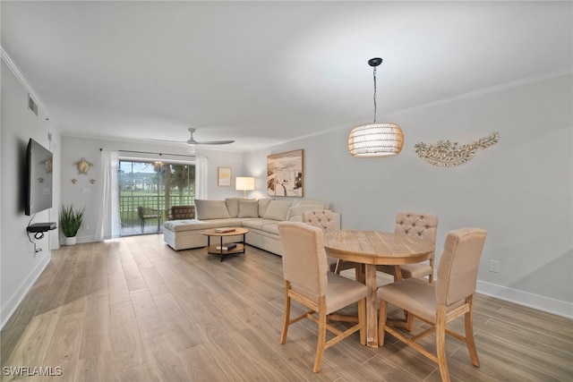 dining room featuring ceiling fan, crown molding, and light hardwood / wood-style flooring