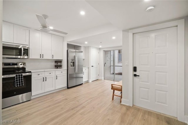 12540 Kelly Greens Blvd Unit 327, Fort Myers, FL 33908 - kitchen with stainless steel appliances, recessed lighting, ceiling fan, white cabinetry, and light countertops