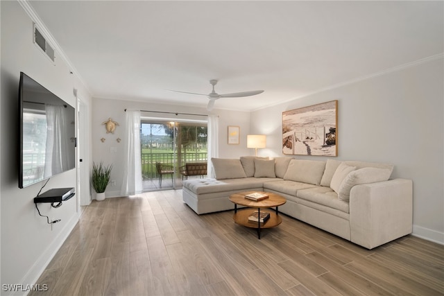 living room featuring hardwood / wood-style floors, ceiling fan, and ornamental molding