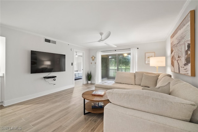 living room with wood-type flooring, ceiling fan, and crown molding