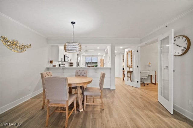 12540 Kelly Greens Blvd Unit 327, Fort Myers, FL 33908 - dining room featuring crown molding, light wood-style floors, baseboards, and recessed lighting
