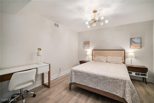 12540 Kelly Greens Blvd Unit 327, Fort Myers, FL 33908 - bedroom featuring a chandelier, wood finished floors, baseboards, and an office area