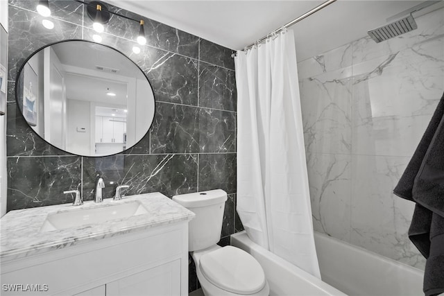 full bathroom featuring tasteful backsplash, toilet, shower / bath combo with shower curtain, vanity, and tile walls