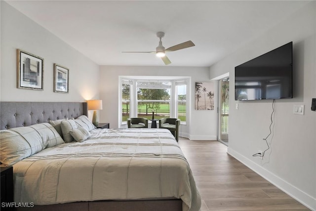 12540 Kelly Greens Blvd Unit 327, Fort Myers, FL 33908 - bedroom with wood finished floors, baseboards, access to exterior, and ceiling fan