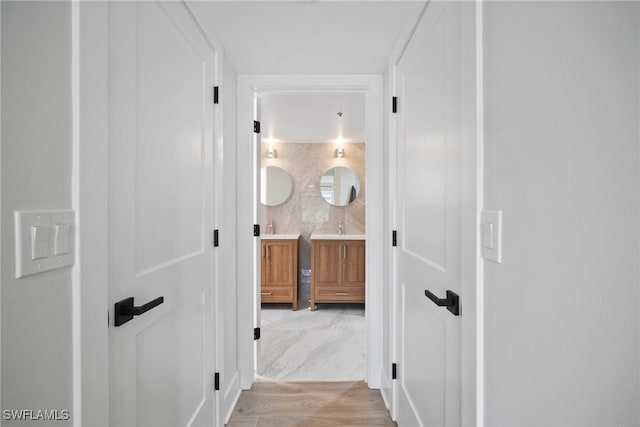 hall featuring light wood-type flooring and sink