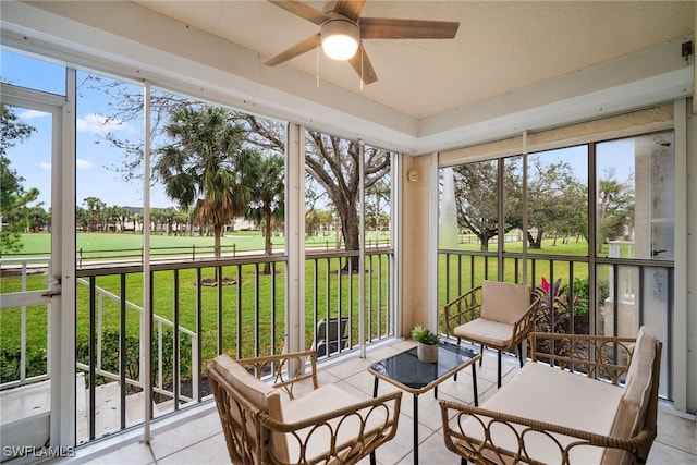 sunroom featuring ceiling fan