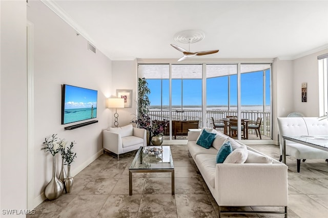 living room featuring a wall of windows, ceiling fan, and crown molding