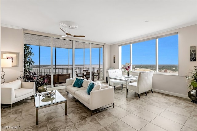 sunroom / solarium featuring ceiling fan and a water view