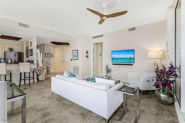 living room with ceiling fan and crown molding