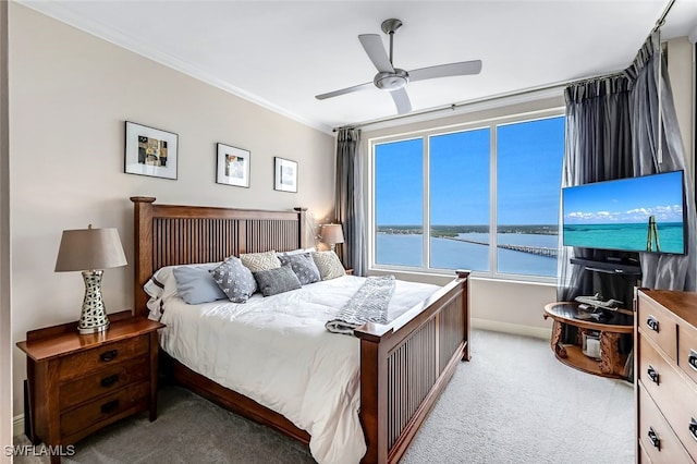 carpeted bedroom with ceiling fan and ornamental molding