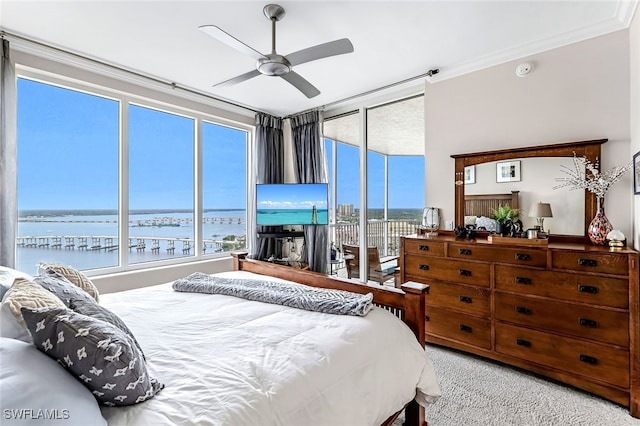 carpeted bedroom featuring access to outside, ceiling fan, and ornamental molding