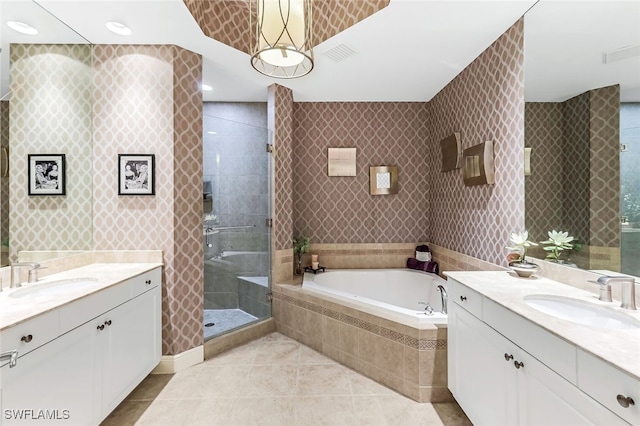 bathroom with shower with separate bathtub, vanity, and tile patterned floors