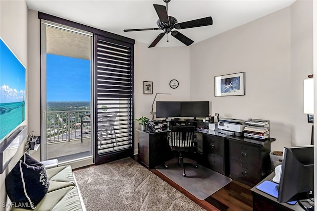 home office with dark hardwood / wood-style flooring and ceiling fan