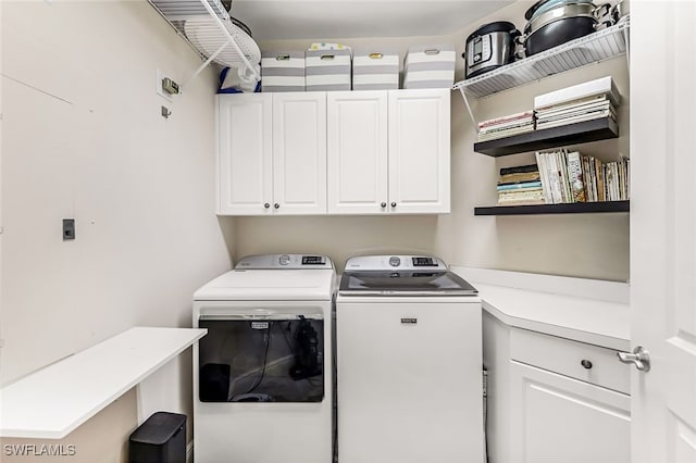 laundry area with washer and clothes dryer and cabinets