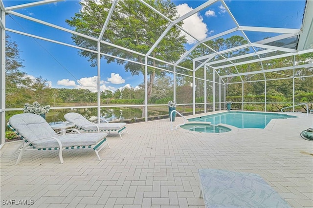 view of pool featuring glass enclosure, an in ground hot tub, a water view, and a patio