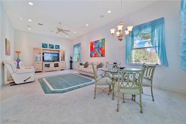 tiled dining room with ceiling fan with notable chandelier