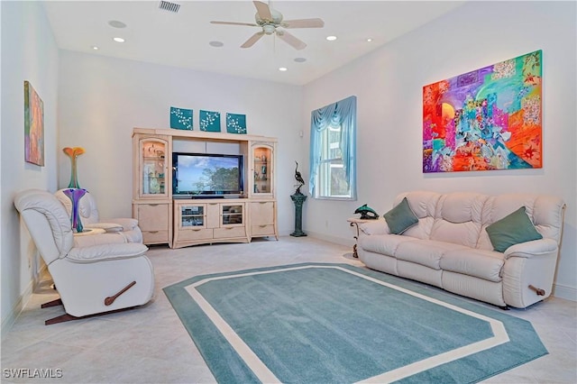 living room with ceiling fan and tile patterned flooring