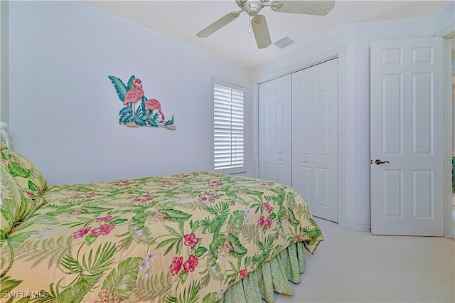 bedroom featuring ceiling fan, a closet, and light carpet