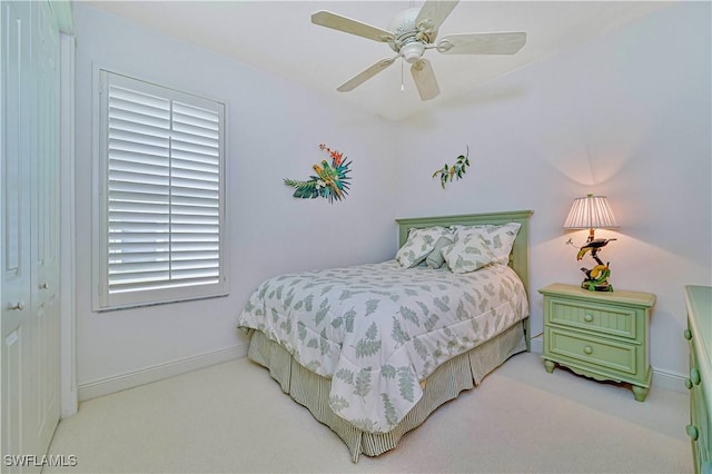 carpeted bedroom with ceiling fan and a closet