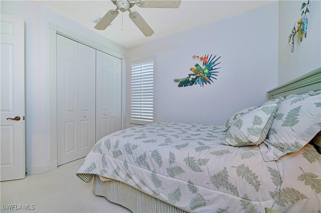 carpeted bedroom with ceiling fan and a closet