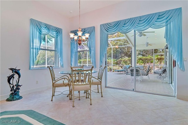 tiled dining room with an inviting chandelier