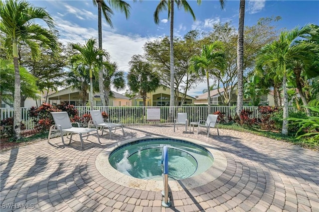 view of swimming pool with a patio area and a community hot tub